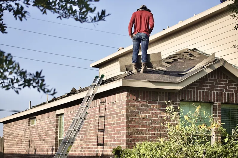 Professional roofer working on a residential roof in Rockstone